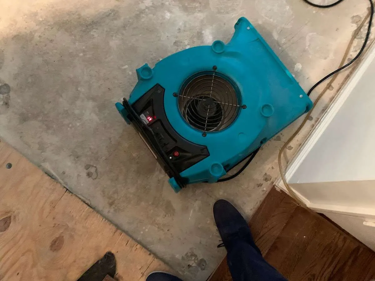 Air mover drying subfloor during Commercial Water Damage Restoration in Prairie View